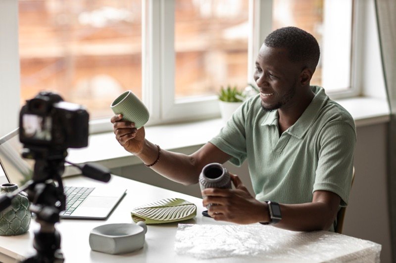 A creator filming product content for his small business