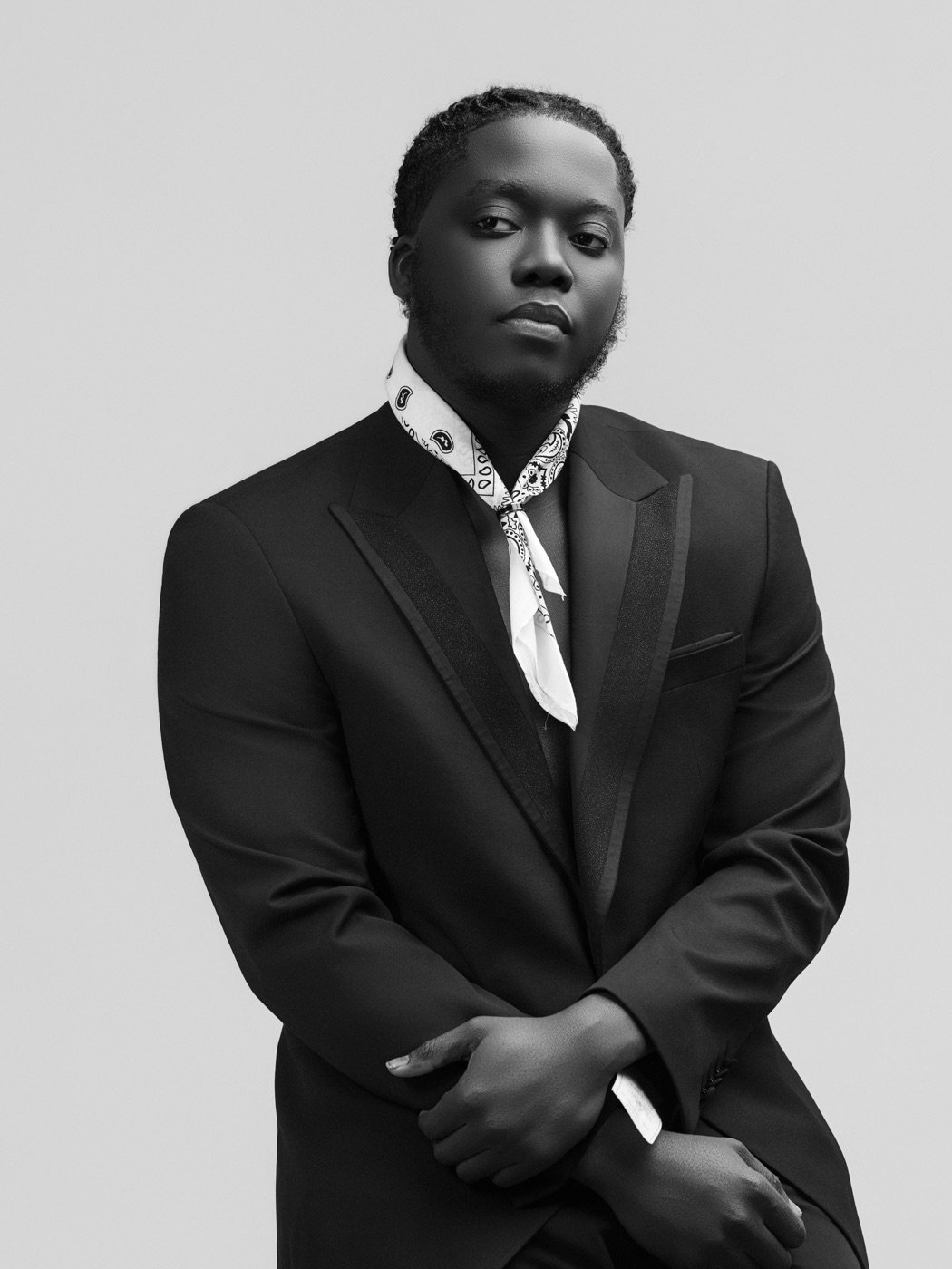 Francisco Vilton in a black suit and white bandana
